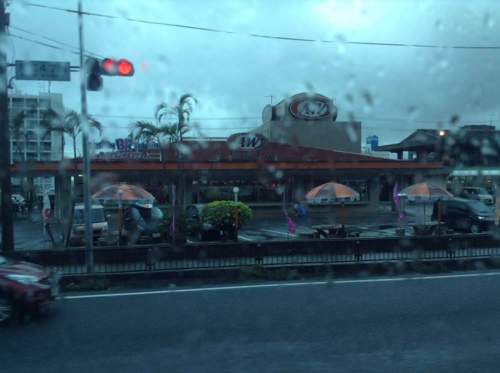 View from the bus of an A&W restaurant on a rainy day